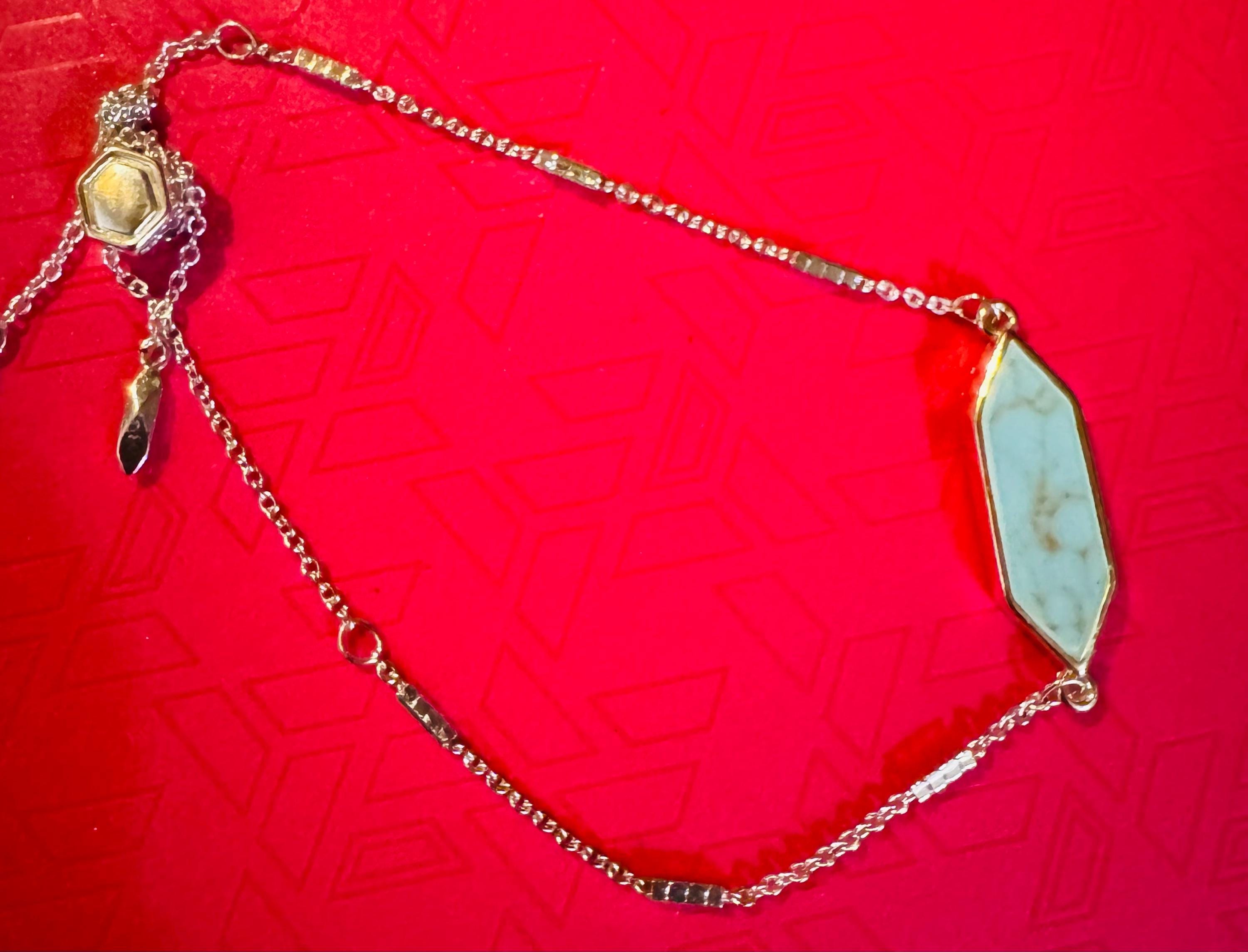 Adjustable Silver Toned Bracelet w/ Blue Colored Stone.