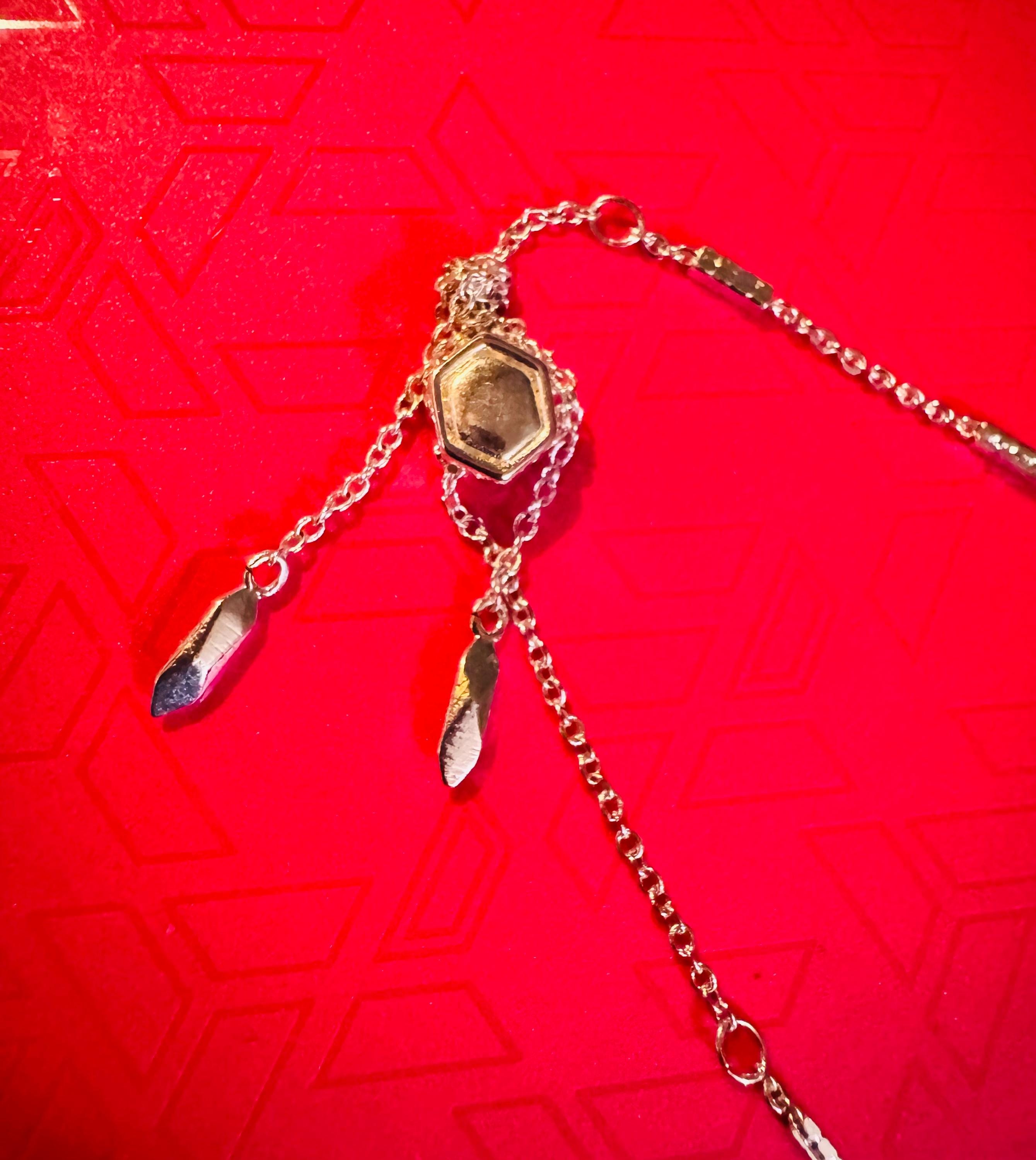 Adjustable Silver Toned Bracelet w/ Blue Colored Stone.